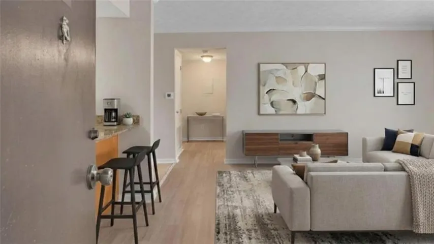 Living area featuring light wood-style floors and baseboards
