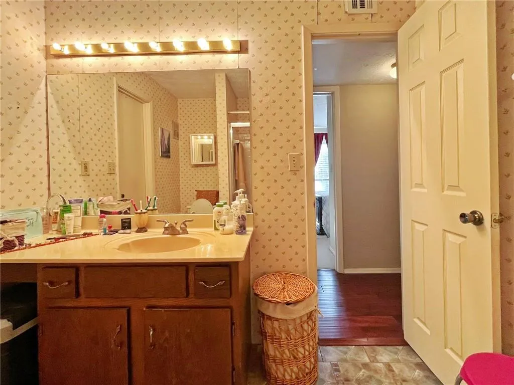 Bathroom with vanity and baseboards