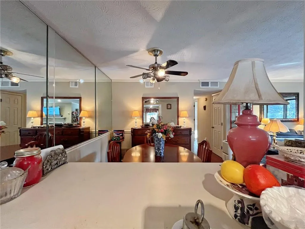 Kitchen featuring a ceiling fan and a textured ceiling