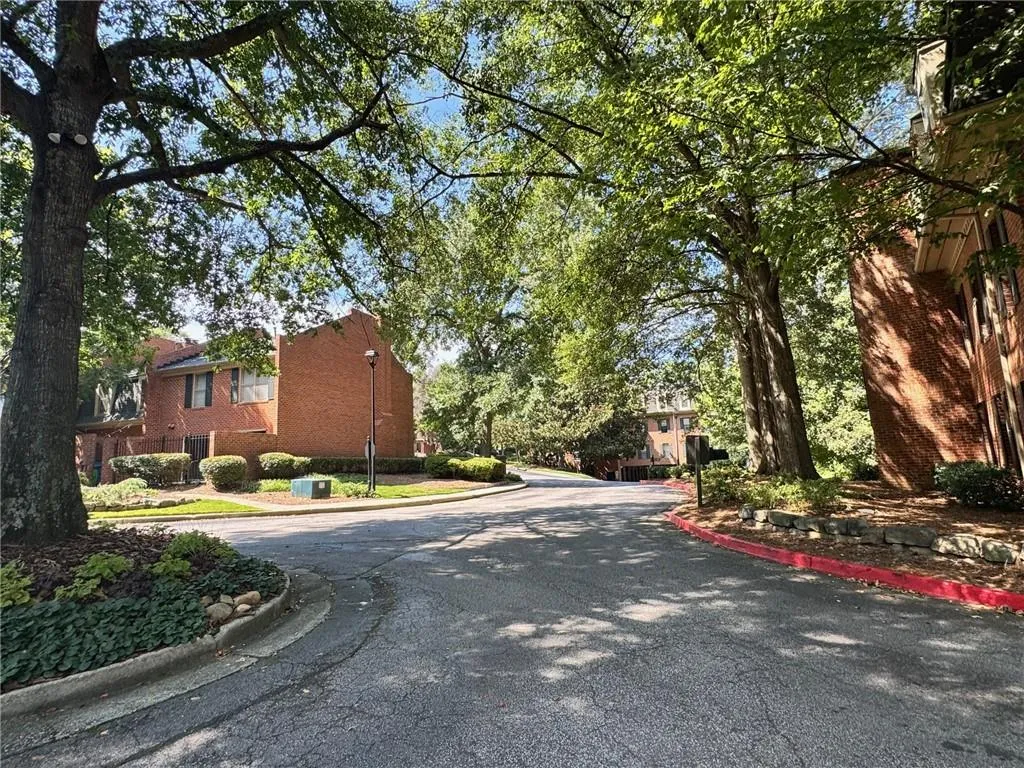 View of asphalt street with curbs and street lighting
