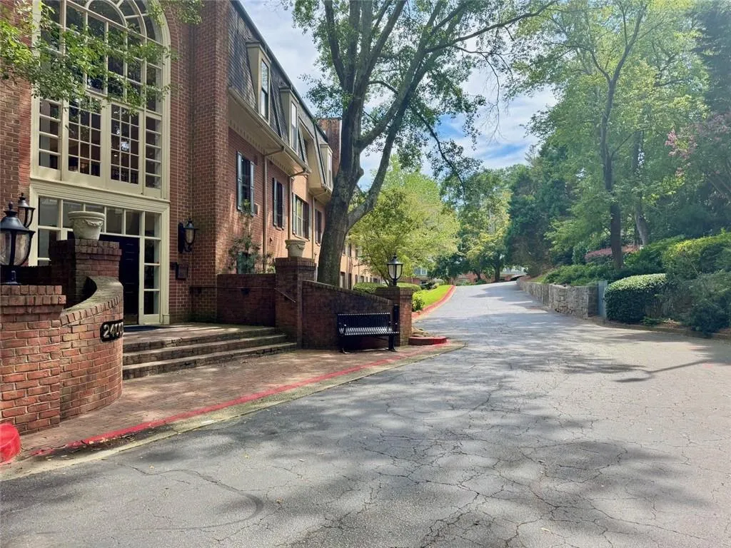View of asphalt road with street lighting and curbs