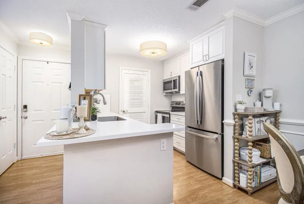 The Kitchen features White Cabinets to the ceiling, Stone Countertops, Stainless Steel Appliances, and a Large Walk-In Pantry and Laundry Room.