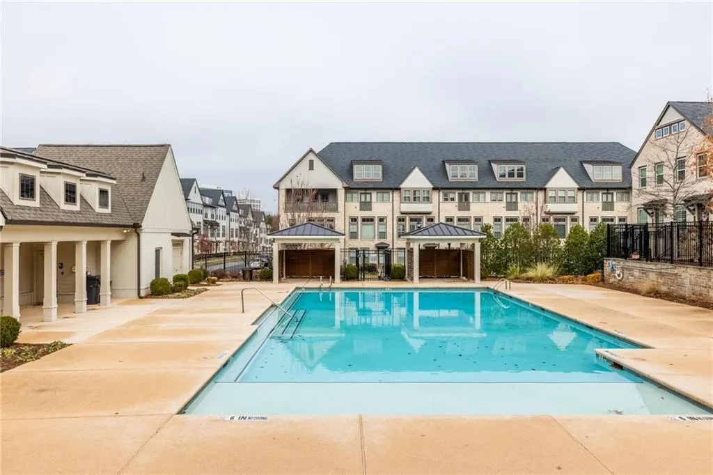 Community pool featuring a gazebo, a residential view, and a patio area