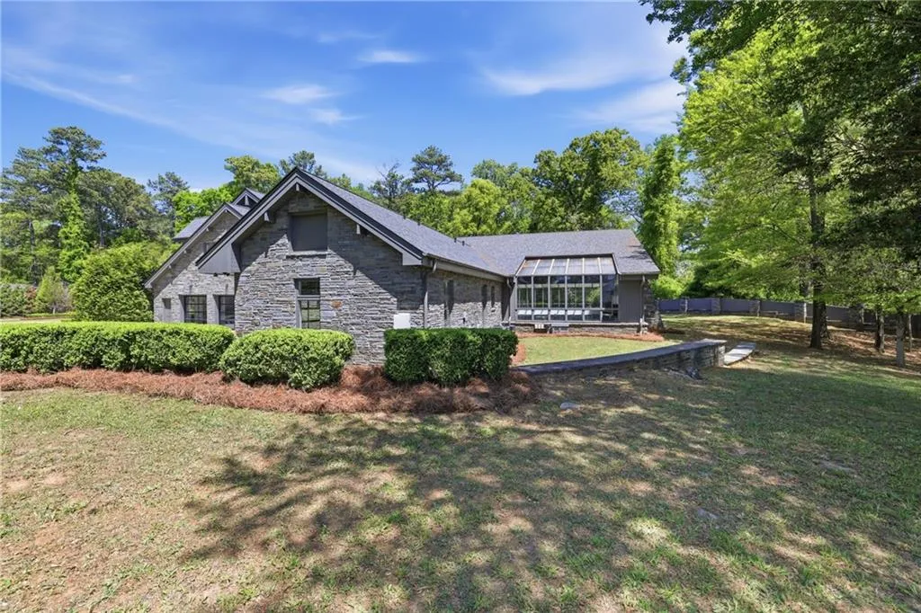 Stone exterior featuring a gabled roofline and multiple windows