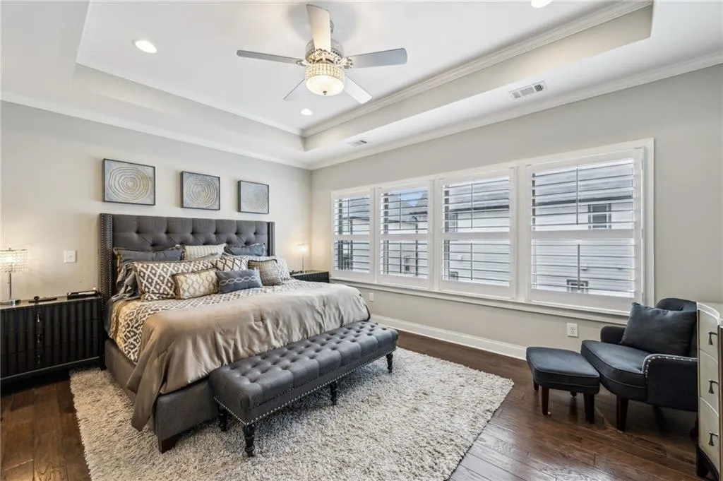 Oversized primary with trey ceilings dark hardwood floors