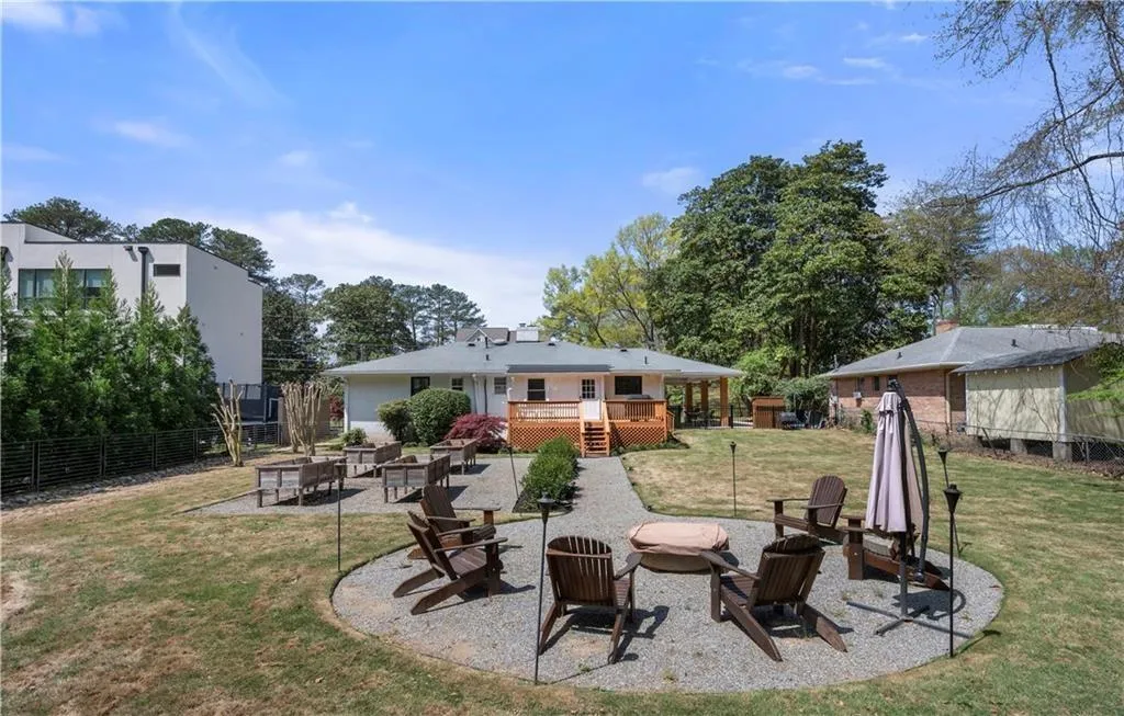 Rear view of property with an outdoor fire pit, a patio, a deck, and stairs