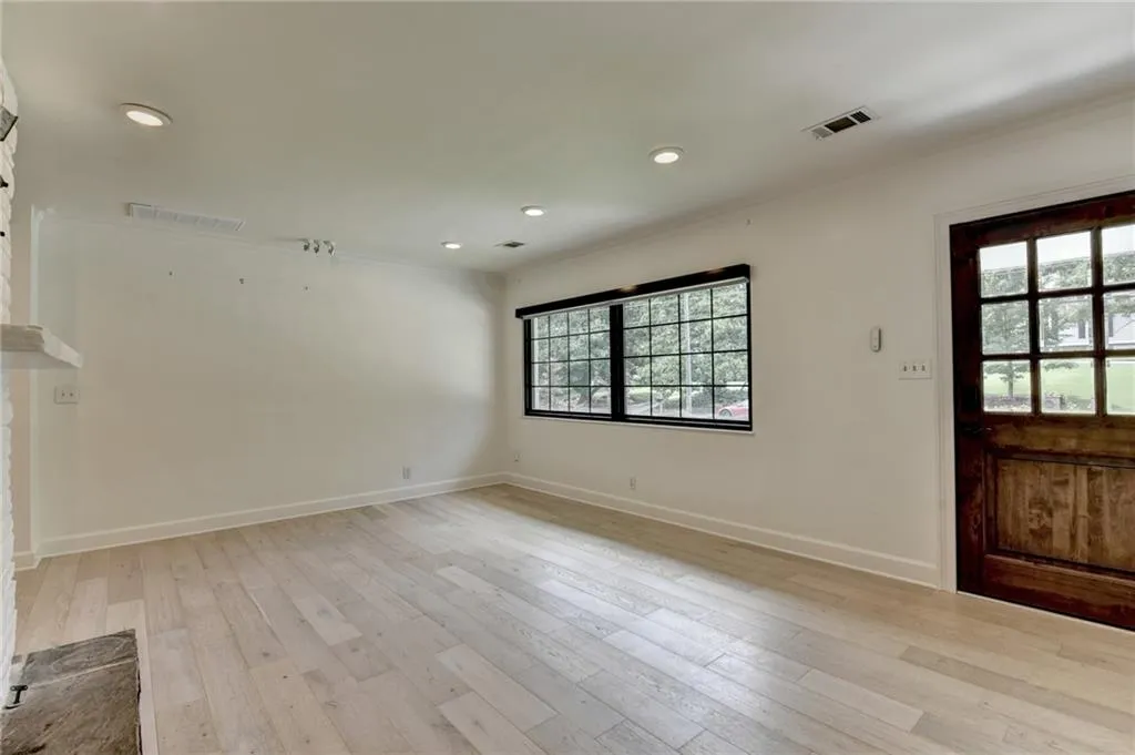 Foyer entrance with recessed lighting, light wood-style floors, and crown molding