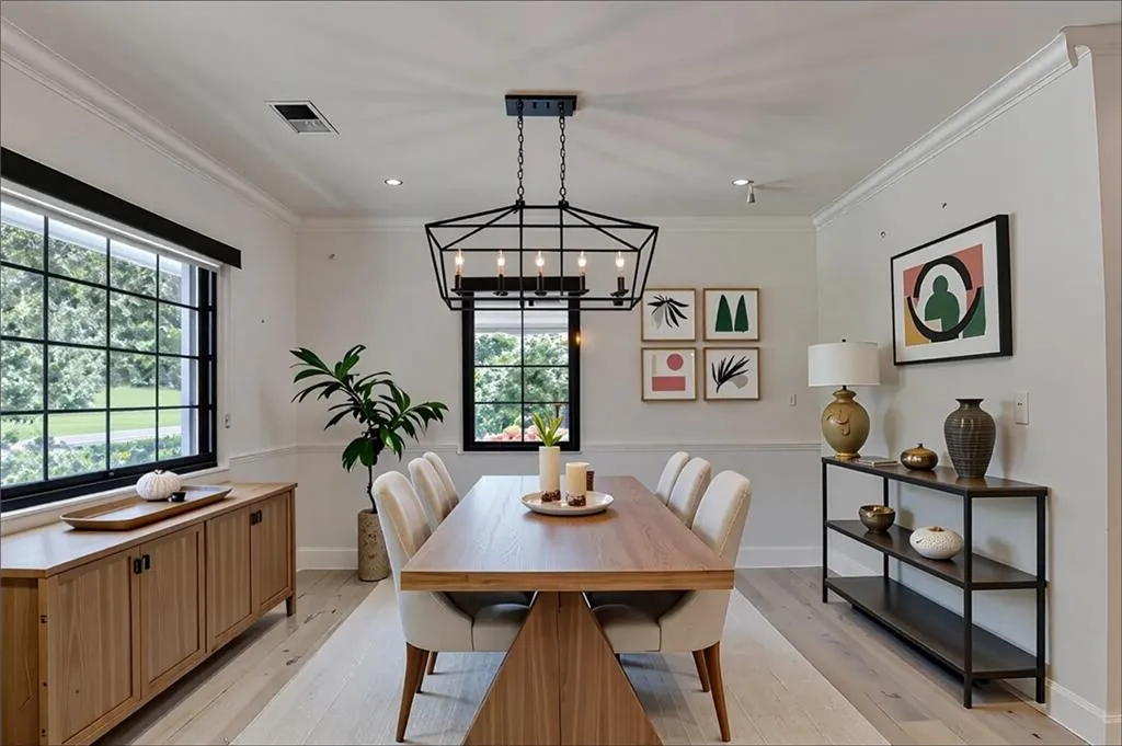 Dining area with crown molding, light wood finished floors, and recessed lighting