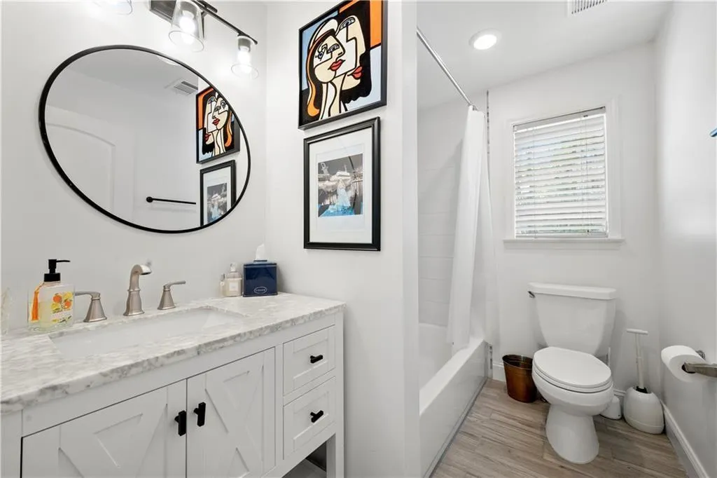 Full bath with vanity, shower / bath combo, light wood-style floors, and recessed lighting
