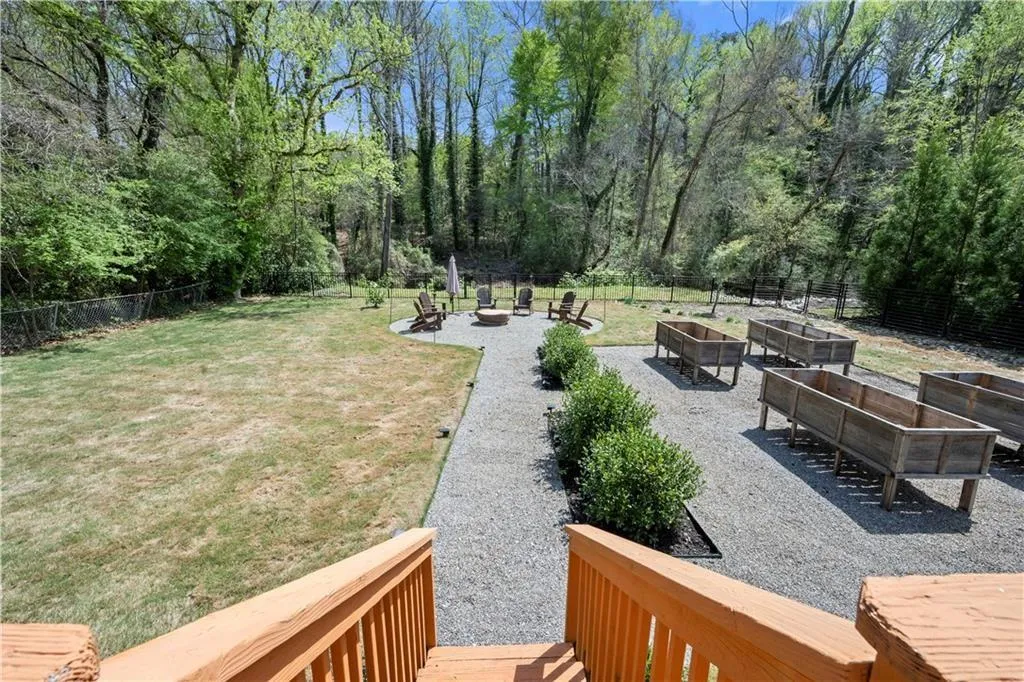 Fenced backyard featuring a patio, an outdoor fire pit, and a garden