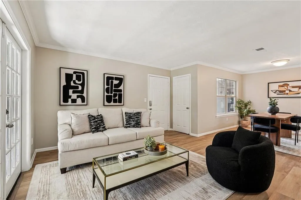 Living area featuring wood finished floors and ornamental molding