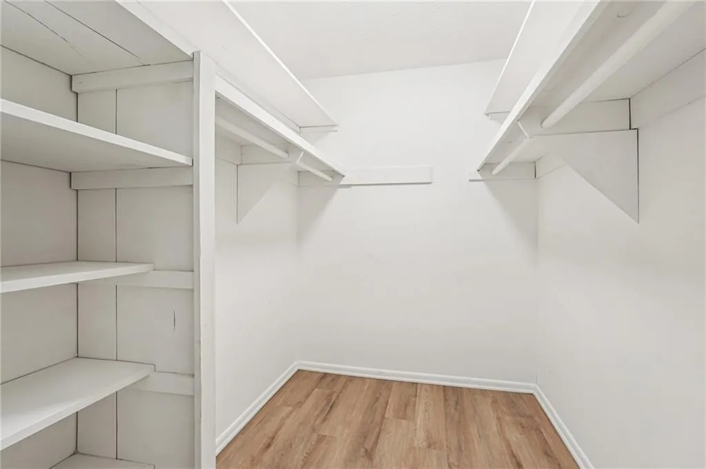 Walk in closet featuring light wood-type flooring