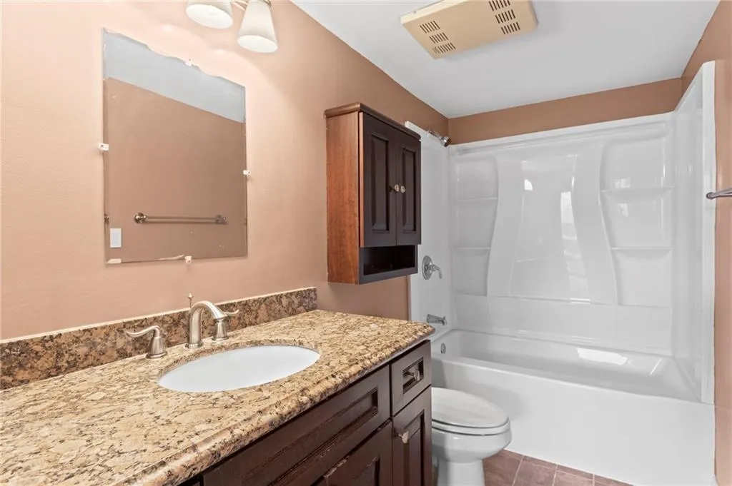 Bathroom with vanity and shower / tub combination