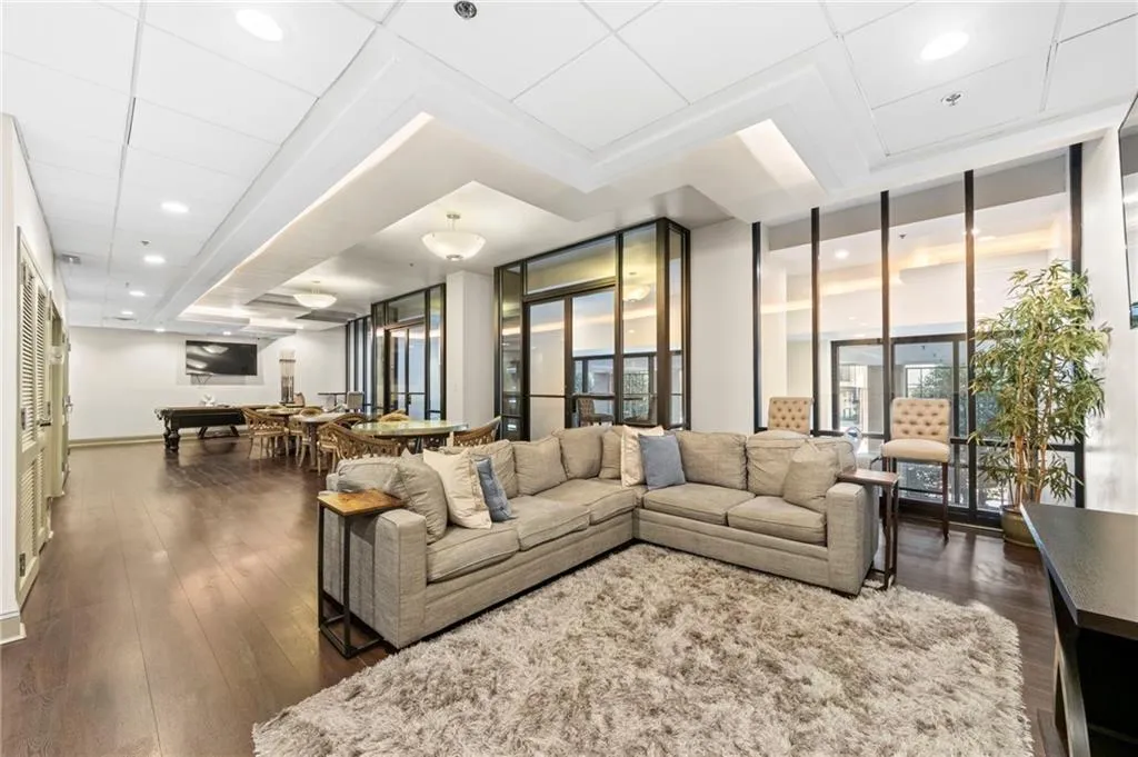 Living area with dark wood-style floors and recessed lighting
