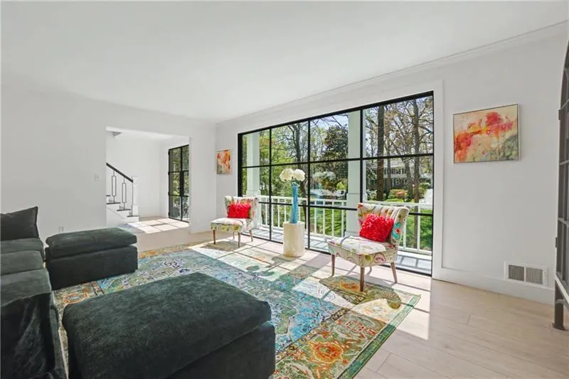 Living area featuring light wood-style floors and ornamental molding