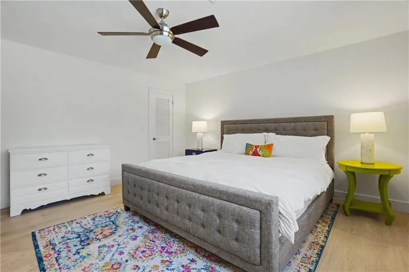 Bedroom with light wood-type flooring and a ceiling fan