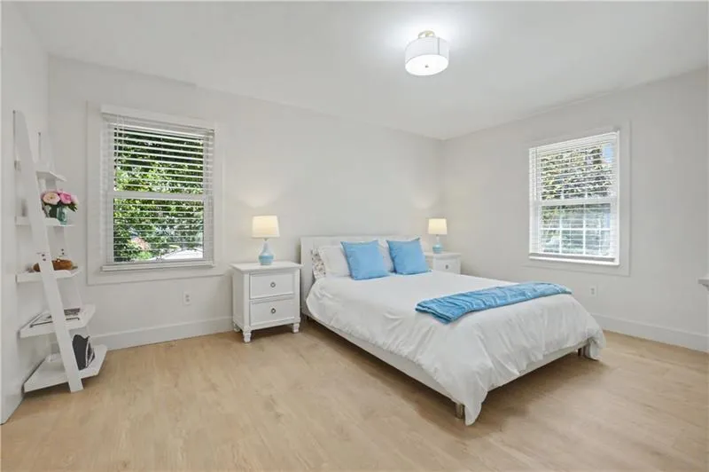 Bedroom featuring light wood finished floors and baseboards