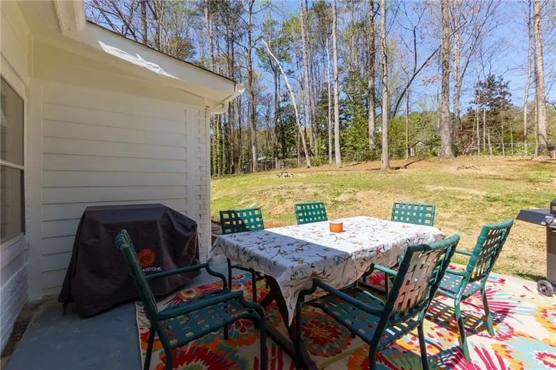 View of patio with a grill and outdoor dining area
