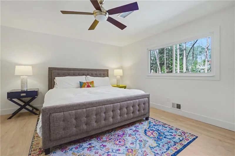 Bedroom with a ceiling fan and light wood-type flooring
