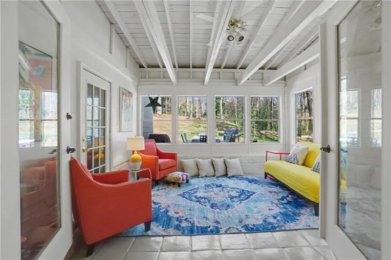 Sunroom / solarium featuring french doors and vaulted ceiling with beams