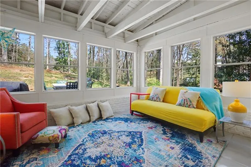 Sunroom with lofted ceiling with beams