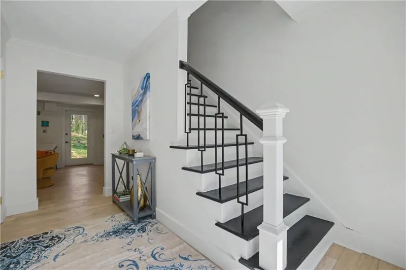 Staircase featuring wood finished floors and baseboards