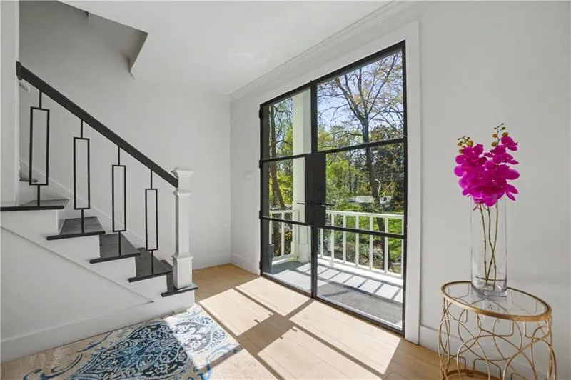 Entryway featuring wood finished floors, crown molding, and french doors