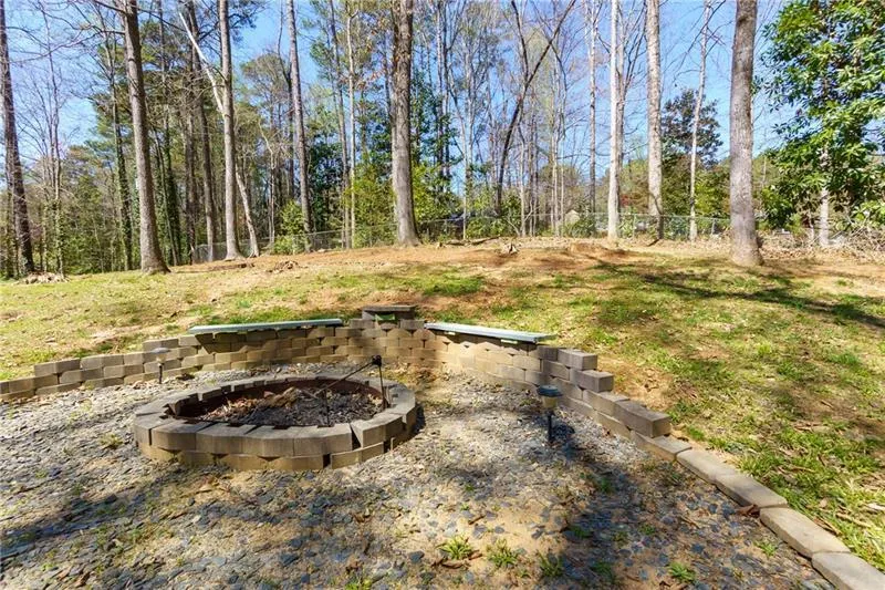 Fenced backyard featuring a fire pit