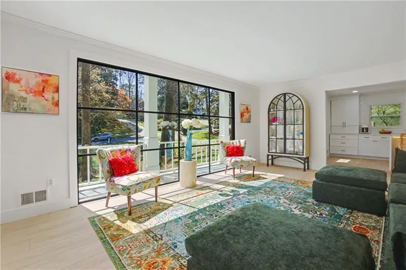Living area with light wood finished floors and ornamental molding