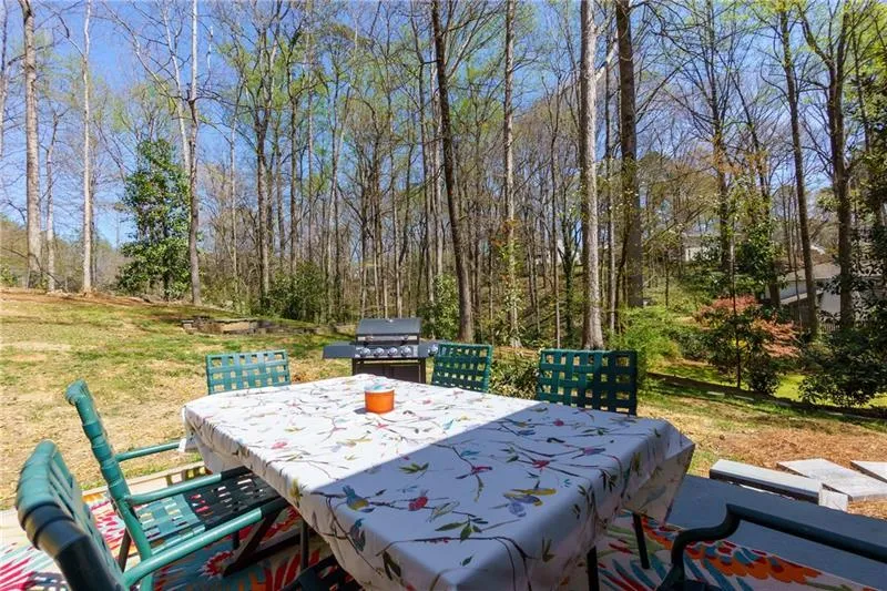 View of patio featuring outdoor dining space and a grill