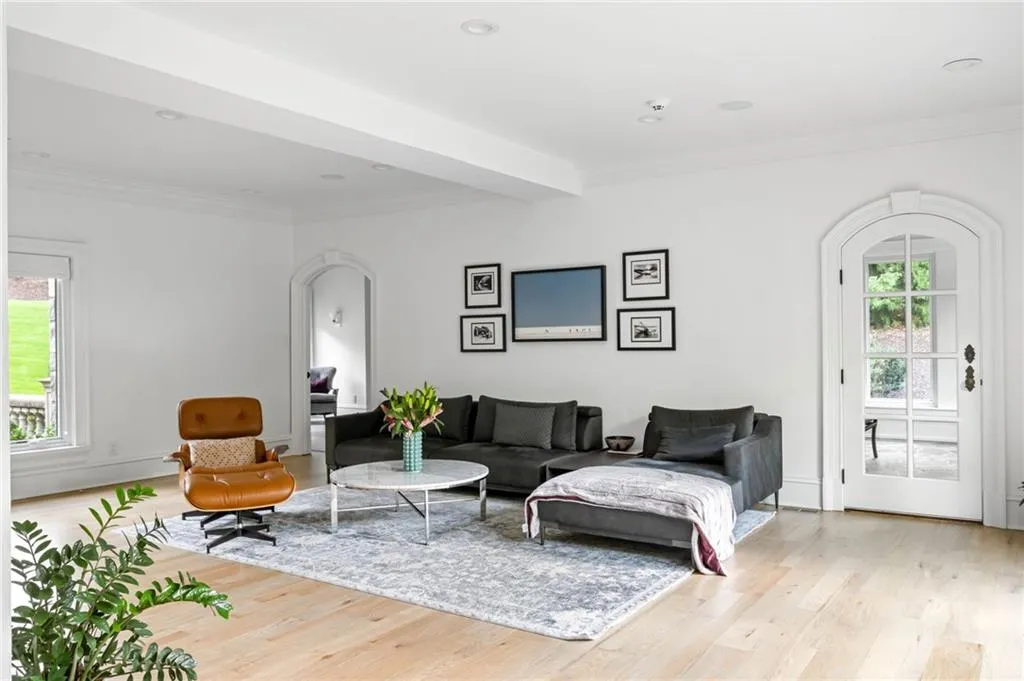 Light wood-finish flooring with white walls and recessed lighting