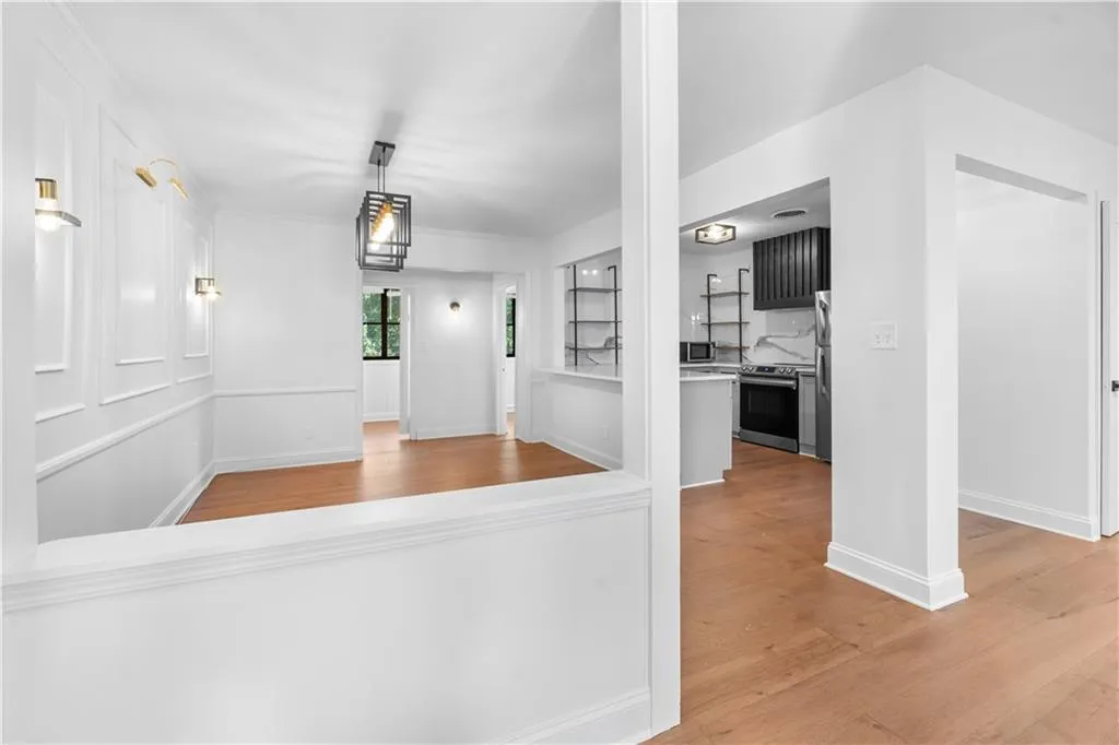Corridor featuring light wood-style floors and baseboards