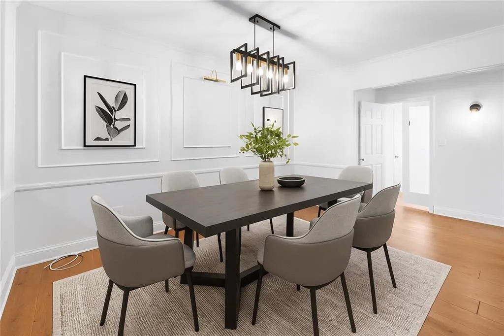 Dining area with light wood-style floors and a decorative wall