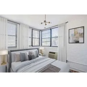 Bedroom featuring a chandelier, a textured wall, and a wall unit AC