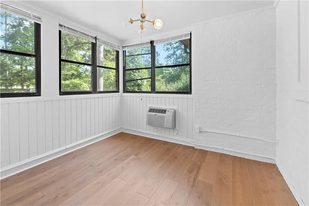 Spare room with light wood-style floors and a chandelier