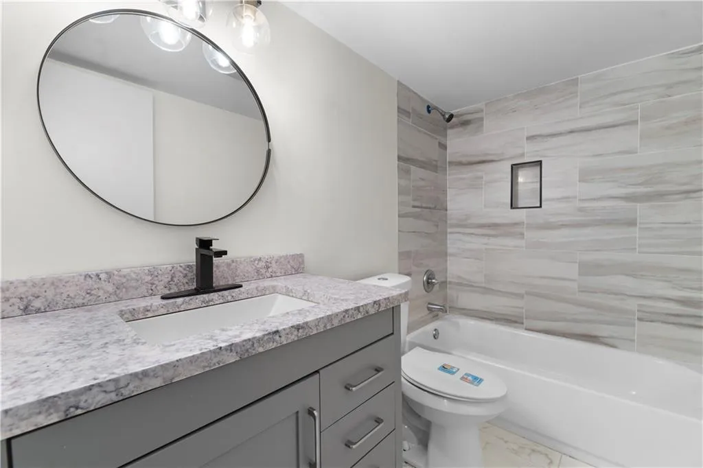 Bathroom featuring shower / washtub combination and vanity