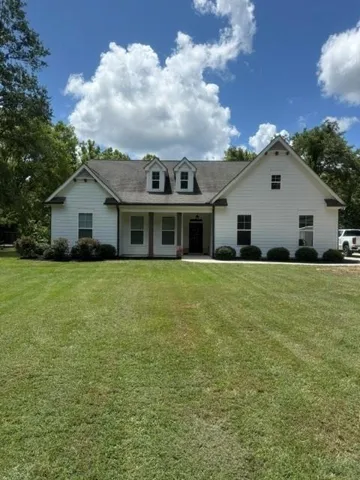 White siding exterior with a dark shingle roof