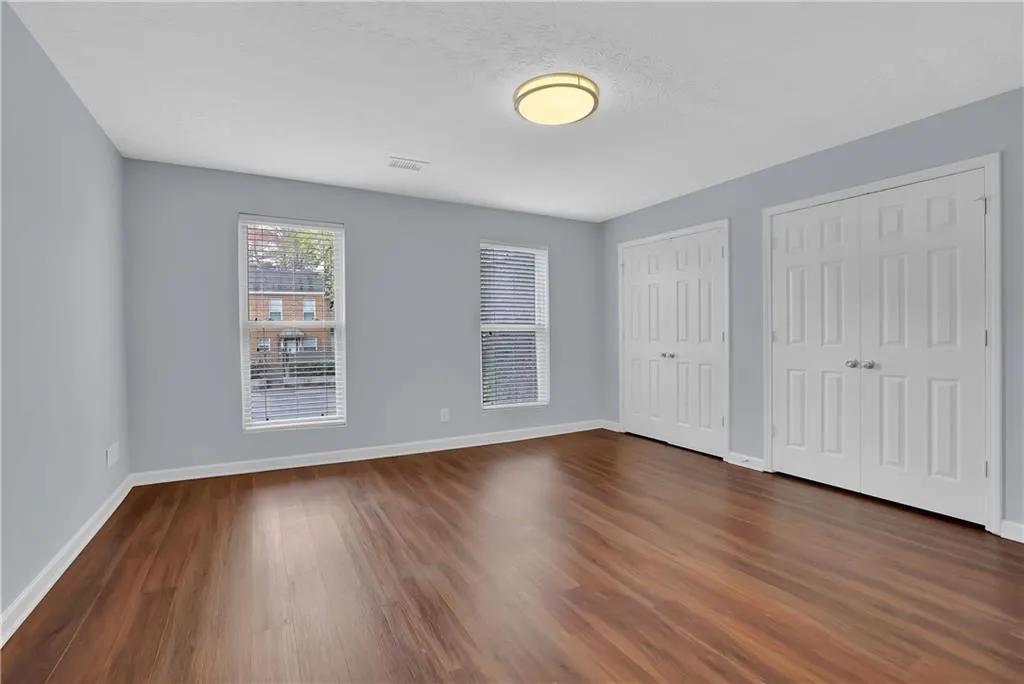 Spare room featuring dark wood-type flooring
