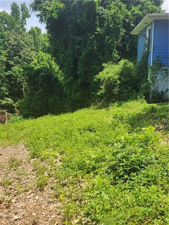 View of yard featuring a view of trees