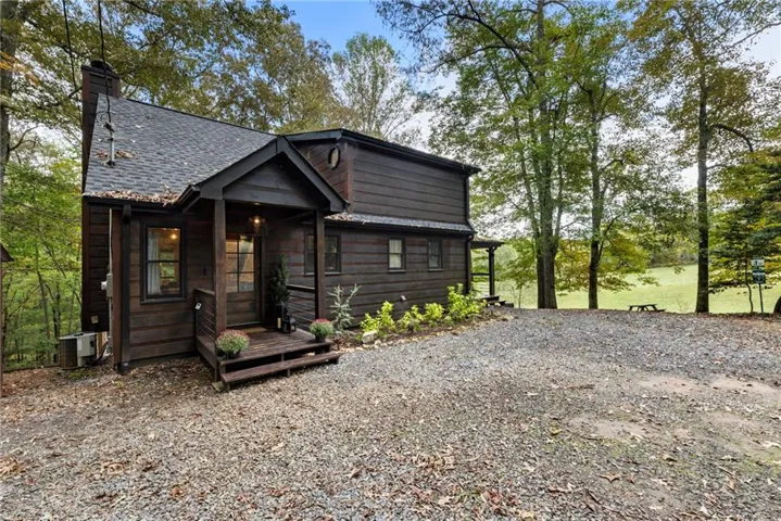Chalet / cabin with a chimney and a deck