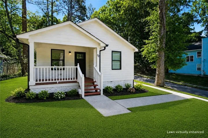 White siding exterior with a covered front porch featuring a white railing and dark wood-finish steps