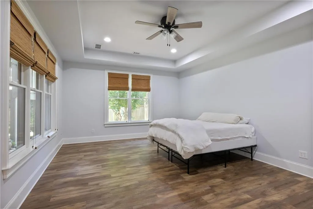 Basement Bedroom featuring a tray ceiling