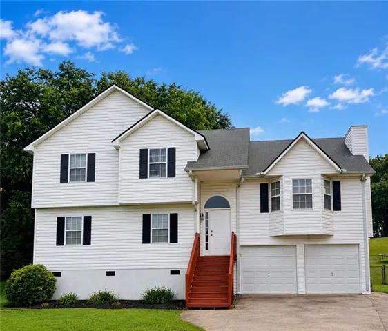 Two-story residence featuring white siding and black shutters