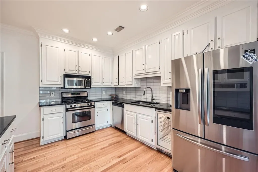 Bright kitchen with pantry, granite counters and stainless appliances.