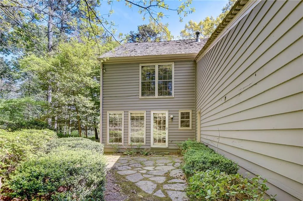 View of exterior entry with a patio area