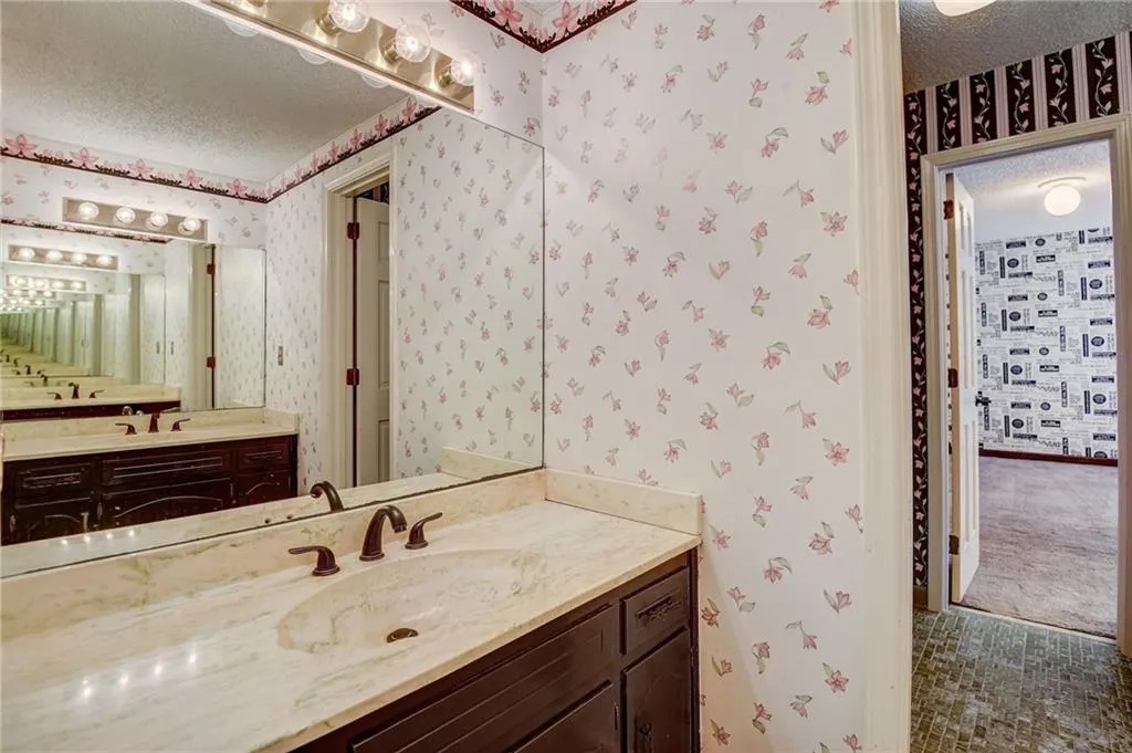 Bathroom with vanity and a textured ceiling