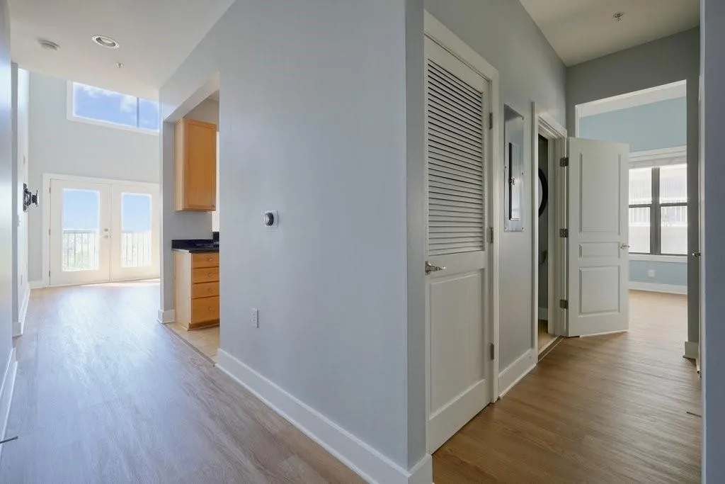 Hall with light wood-type flooring and french doors Hall with light wood-type flooring and french doors