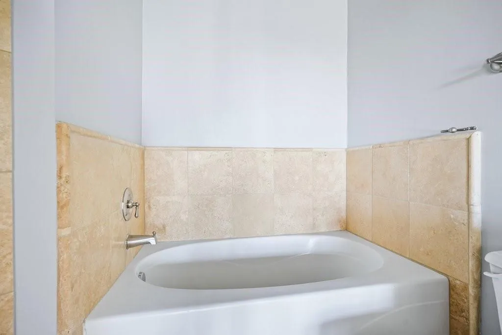 Bathroom featuring a bathtub Bathroom featuring a bathtub