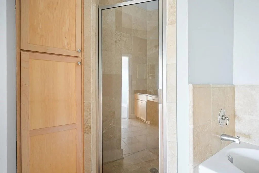 Bathroom featuring tile walls and plus walk in shower Bathroom featuring tile walls and plus walk in shower