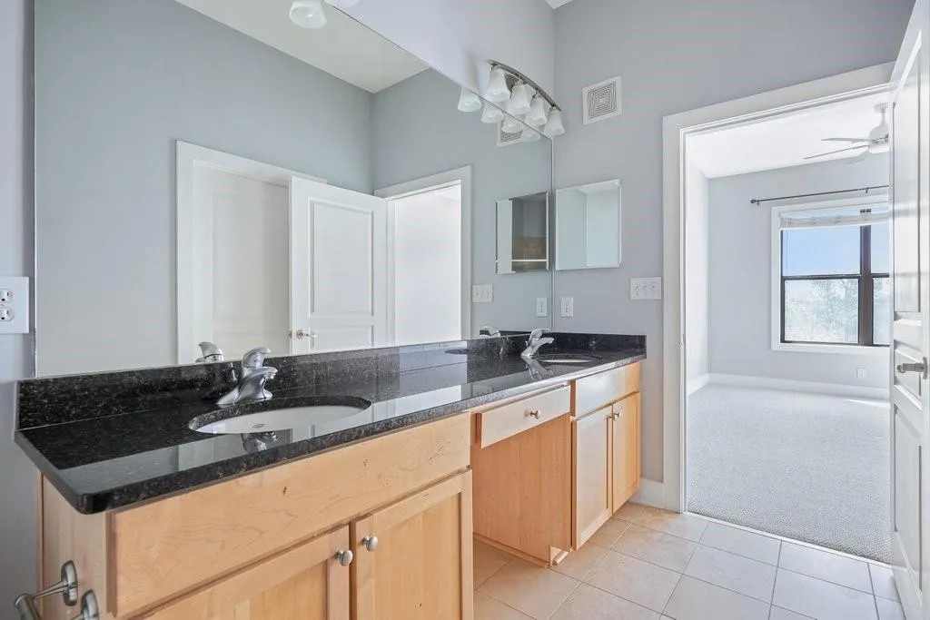 Bathroom with tile floors, dual vanity, and ceiling fan Bathroom with tile floors, dual vanity, and ceiling fan